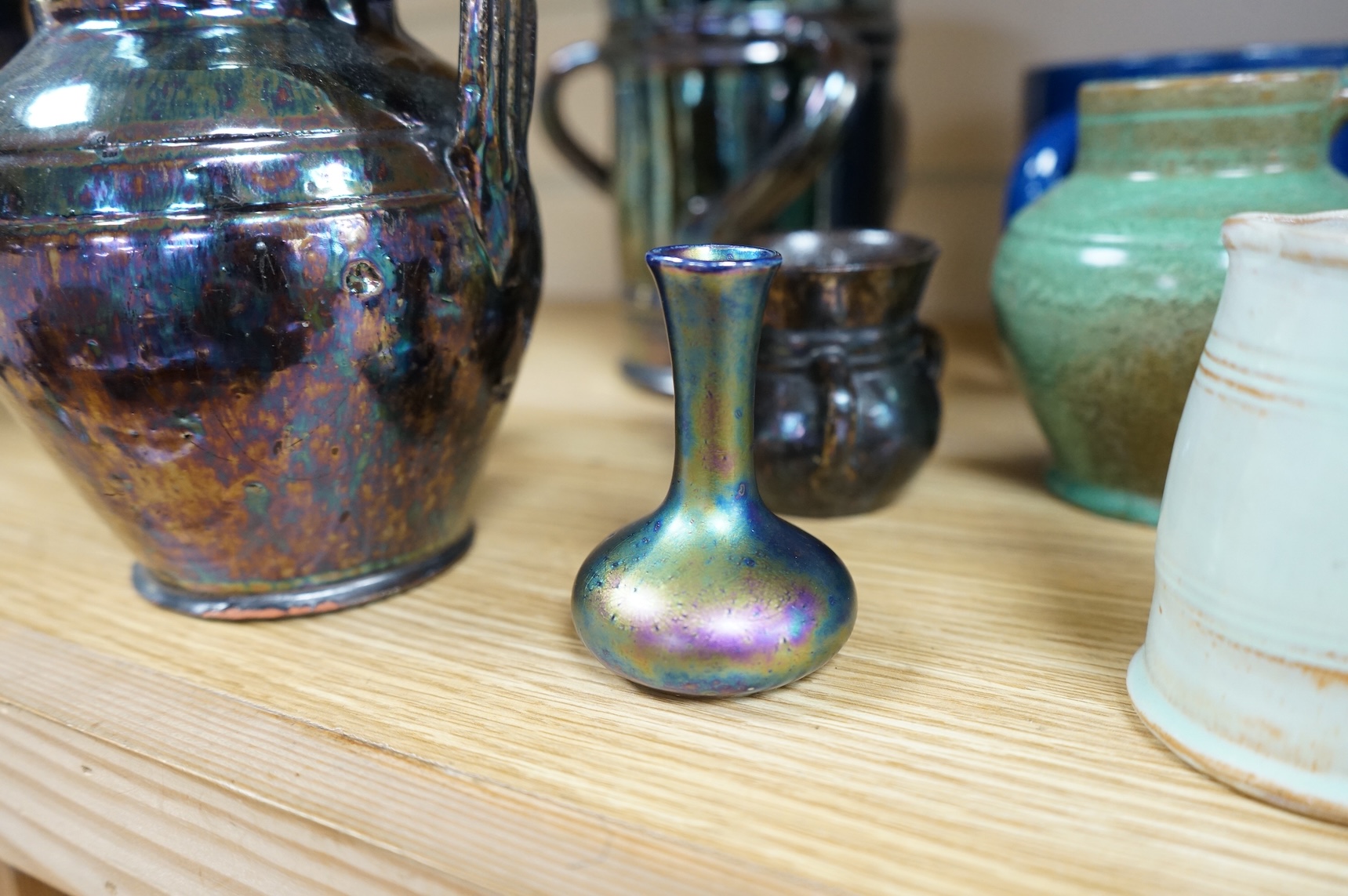 A collection of pottery to include lustre glazed jugs and tygs, a T. G. Green storage jar, Carltonware ash tray and a miniature Ruskin style vase, largest 18cm high
